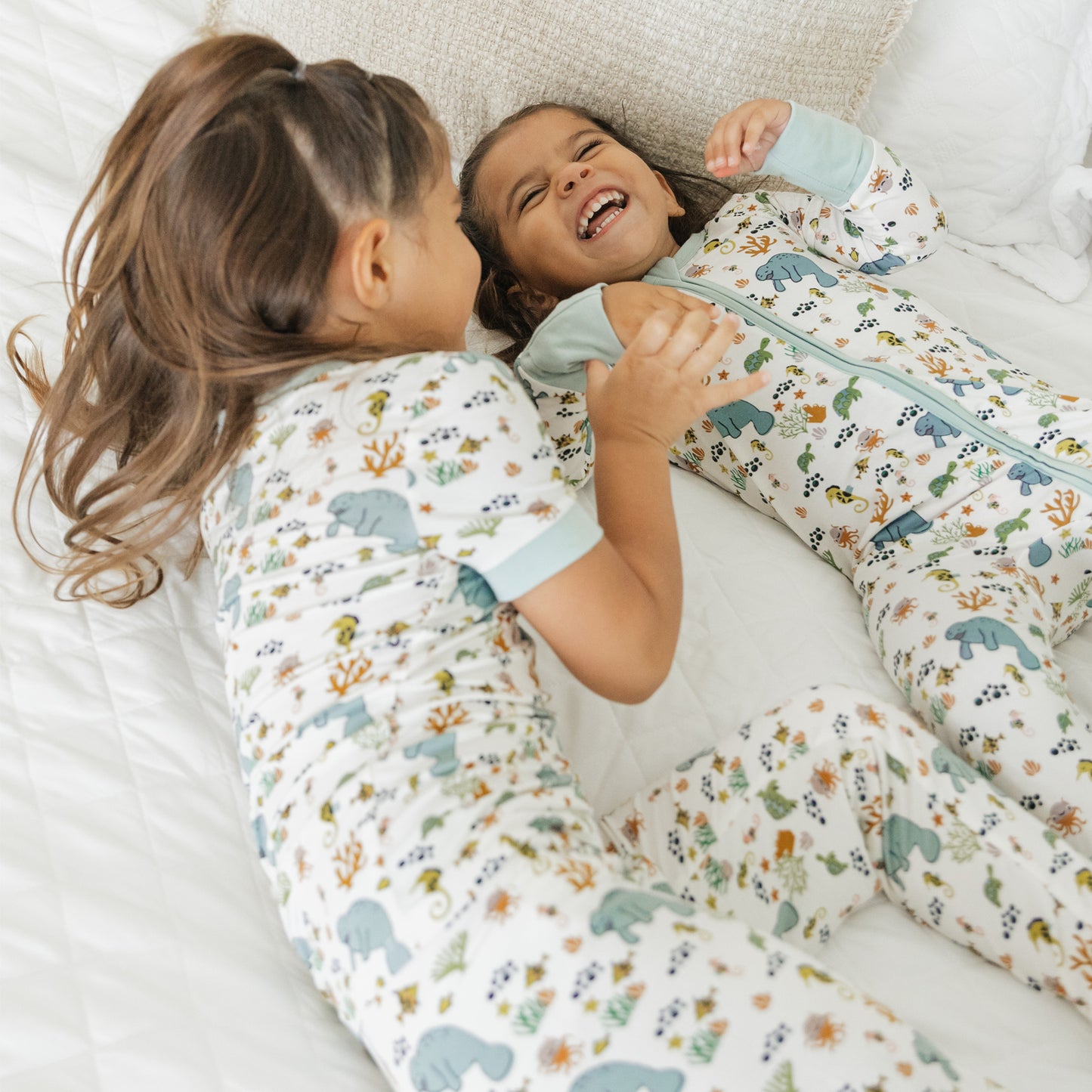 Close up of kids smiling in manatee bamboo pajamas soft breathable fabric for sensitive skin