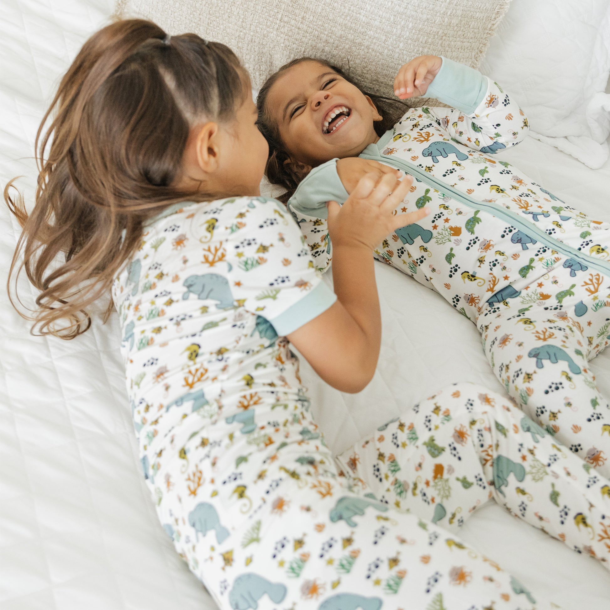 Close up of kids smiling in manatee bamboo pajamas soft breathable fabric for sensitive skin