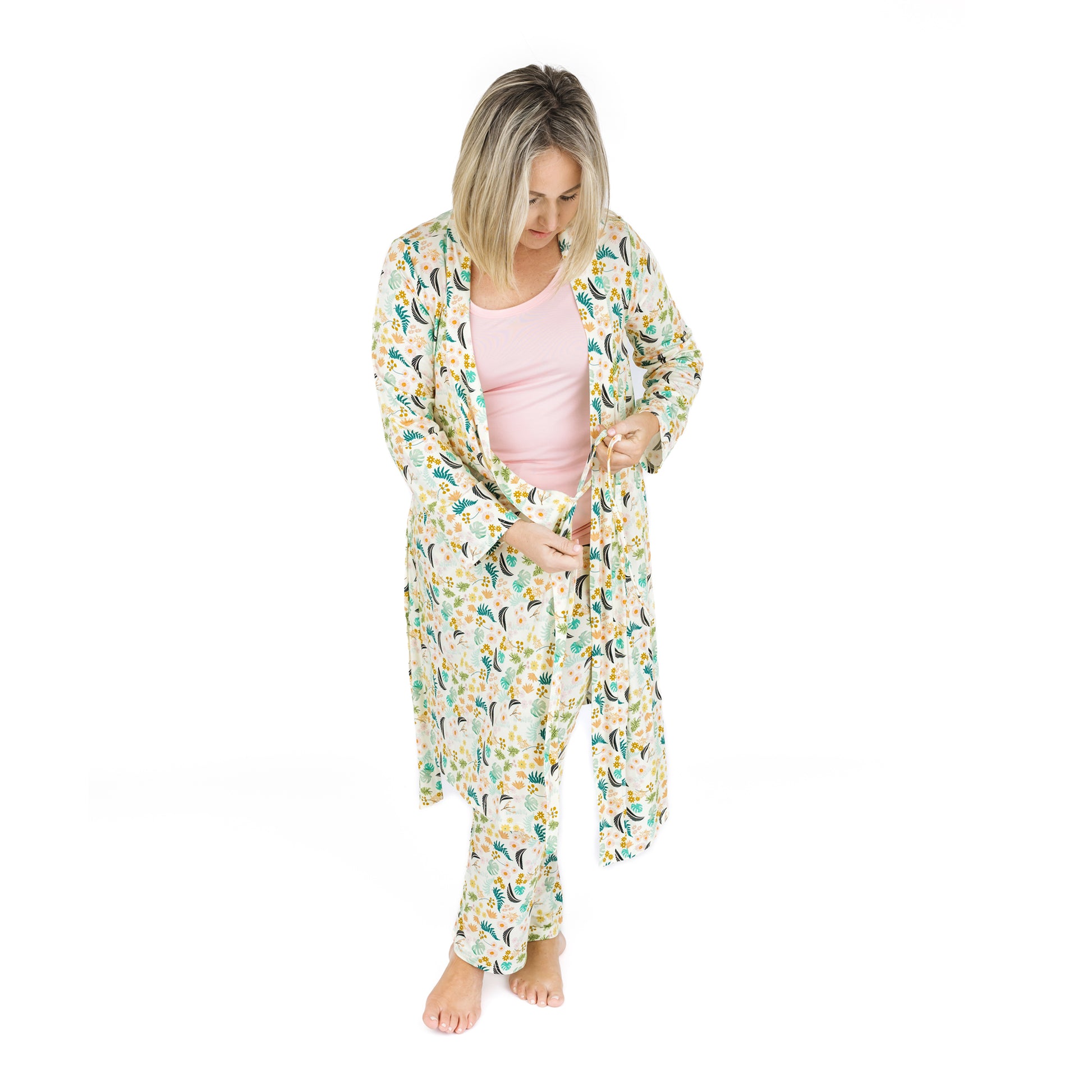 A mother wearing the Tropical Blooms luxury robe while coordinating with her children in matching botanical print styles.