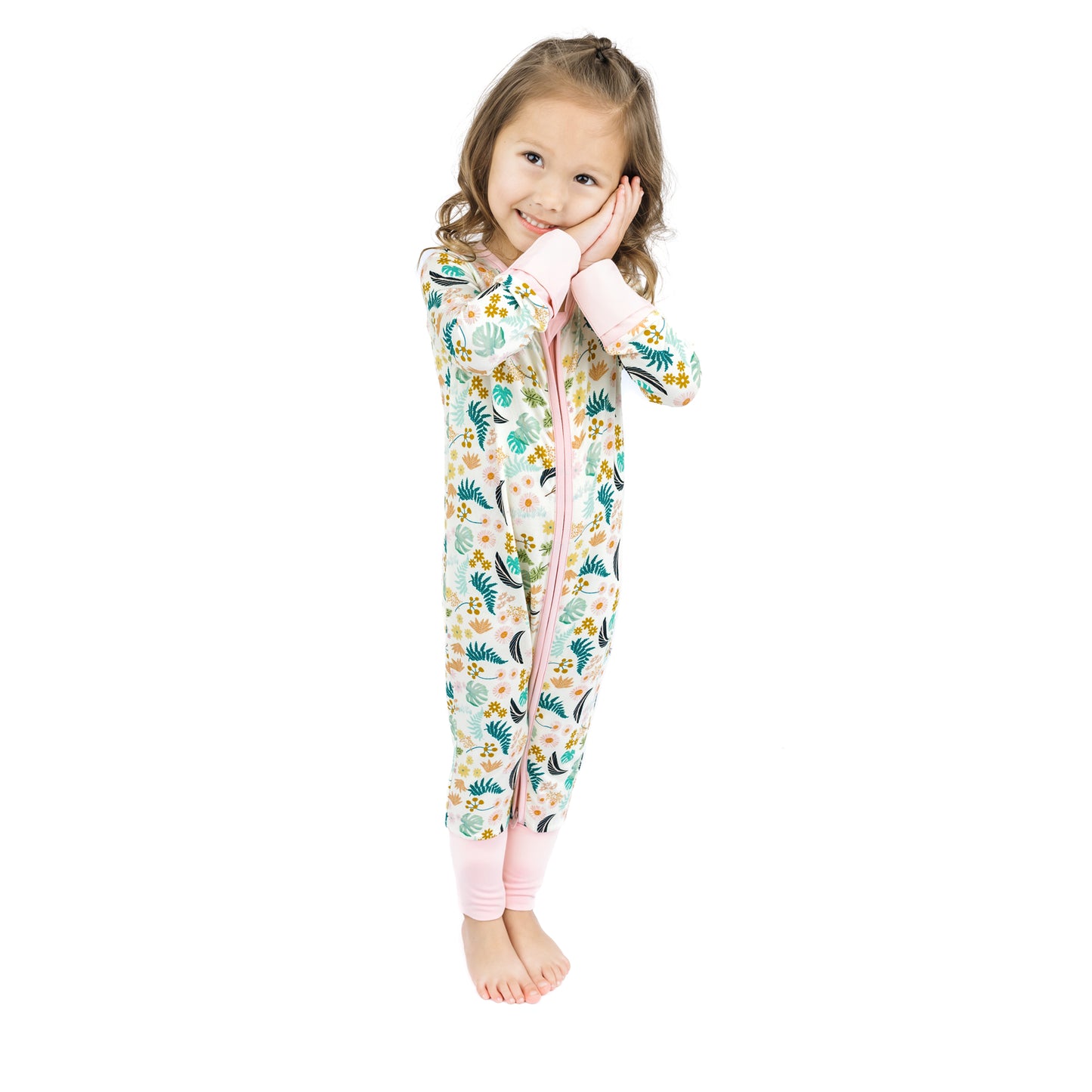 Toddler girl modeling the Tropical Blooms bamboo romper, perfect for coordinated sibling matching looks.