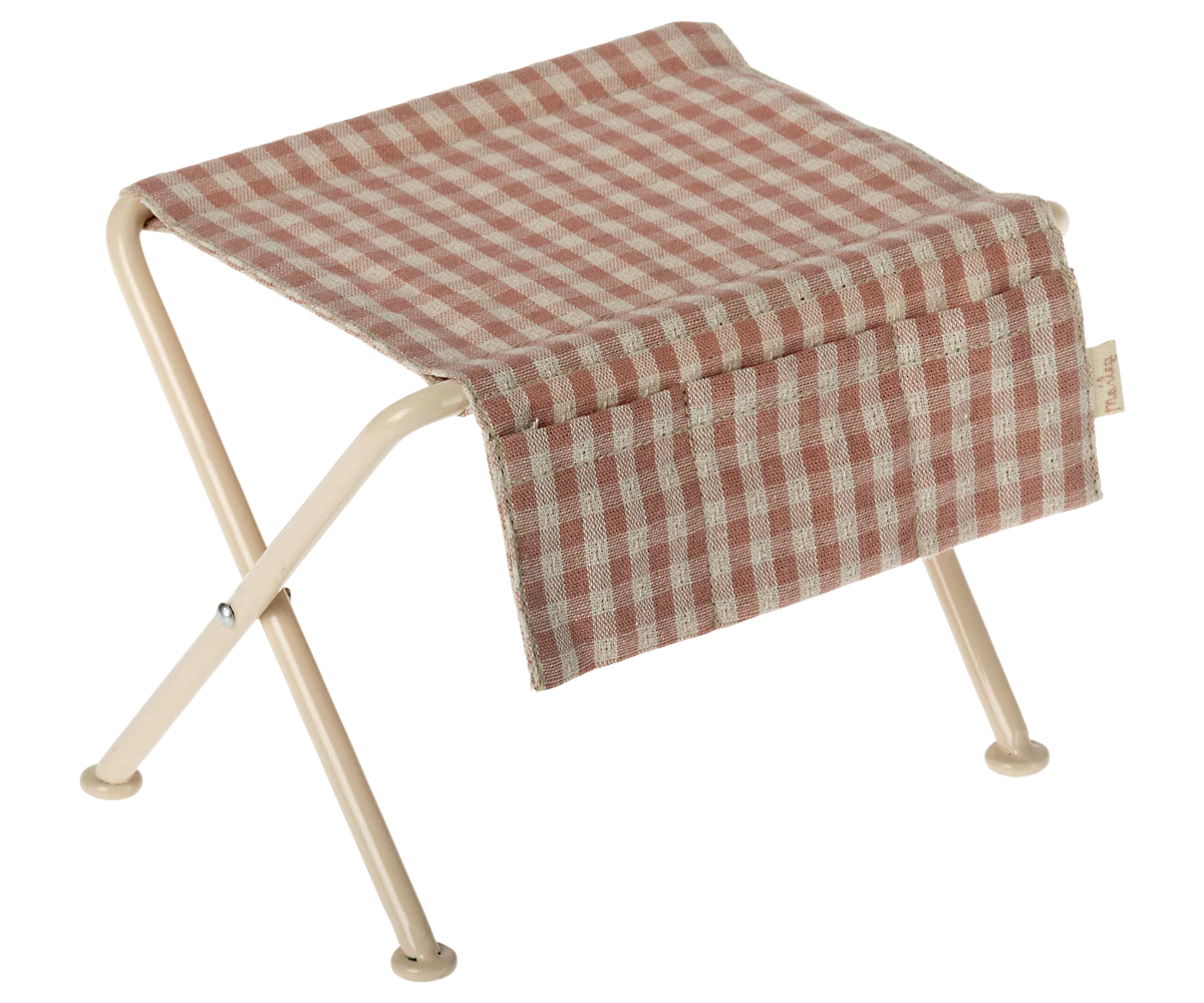 Foldable micro table with a red and white checkered seat on a white background