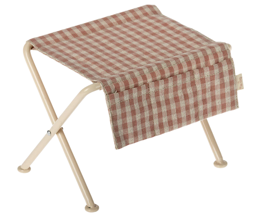 Foldable micro table with a red and white checkered seat on a white background