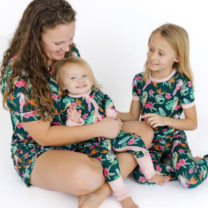 A mother and children wearing matching Isla Botánica tropical print pajamas, perfect for coordinated family style.