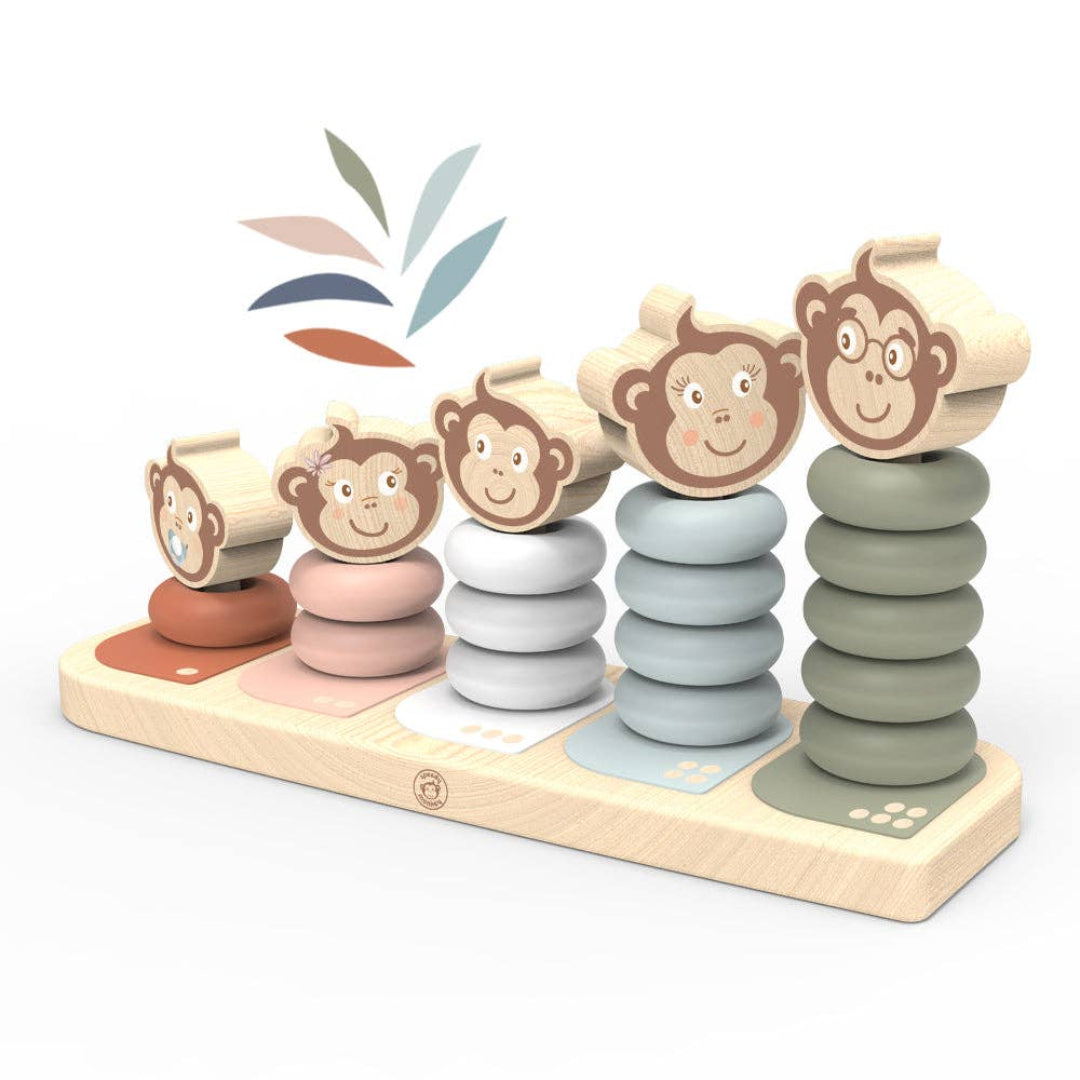 wooden stacking toy with 5 different height posts to stack round blocks on, ranging from short to tall. The blocks are red, pink, light blue, dark blue and green and they all have a monkey head smiling on top