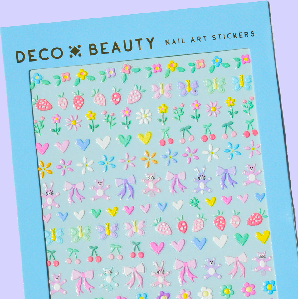 Sheet of nail art stickers with various designs on a blue background