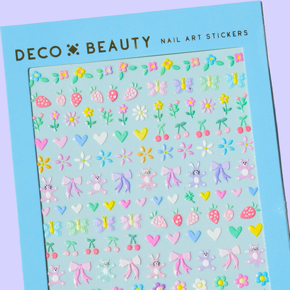 Sheet of nail art stickers with various designs on a blue background