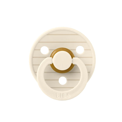 Beige pacifier with gold center on a white background
