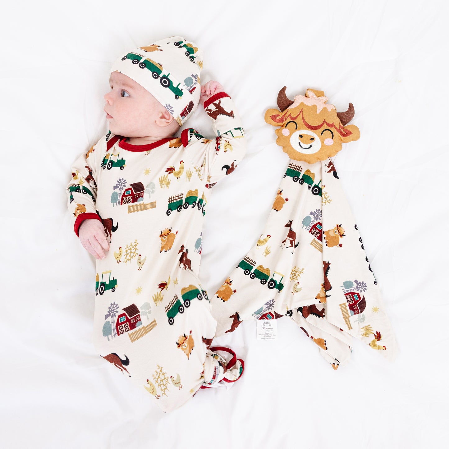 Baby with On the Farm bamboo security blanket lovey and matching gown, soft and breathable for sensitive newborn skin.