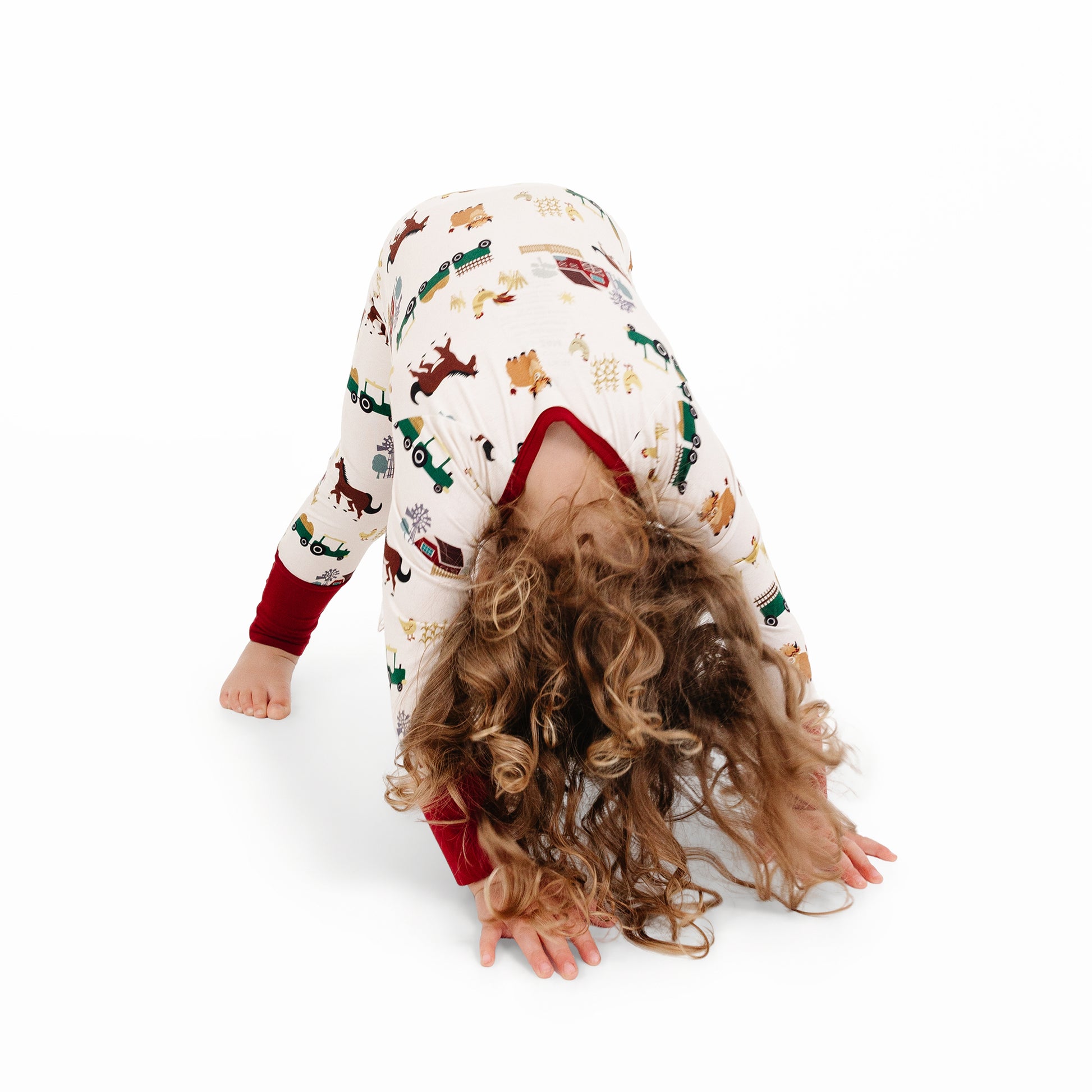 On the Farm bamboo convertible pajamas featuring playful barnyard print with horses, tractors, and cows.