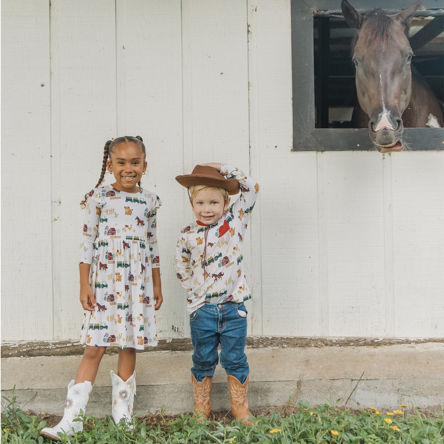 Two siblings wearing matching On the Farm print , breathable and hypoallergenic fabric for sensitive skin.