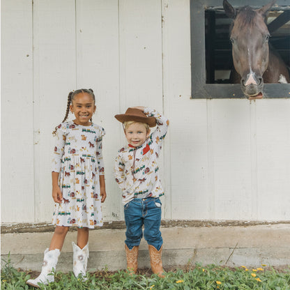 Two siblings wearing matching On the Farm print , breathable and hypoallergenic fabric for sensitive skin.
