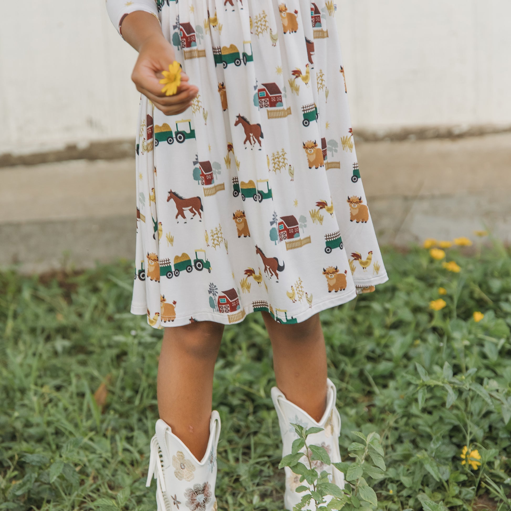 On the Farm bamboo ruffled twirl dress fabric close-up showing tractor and horse print, breathable and hypoallergenic bamboo fabric.