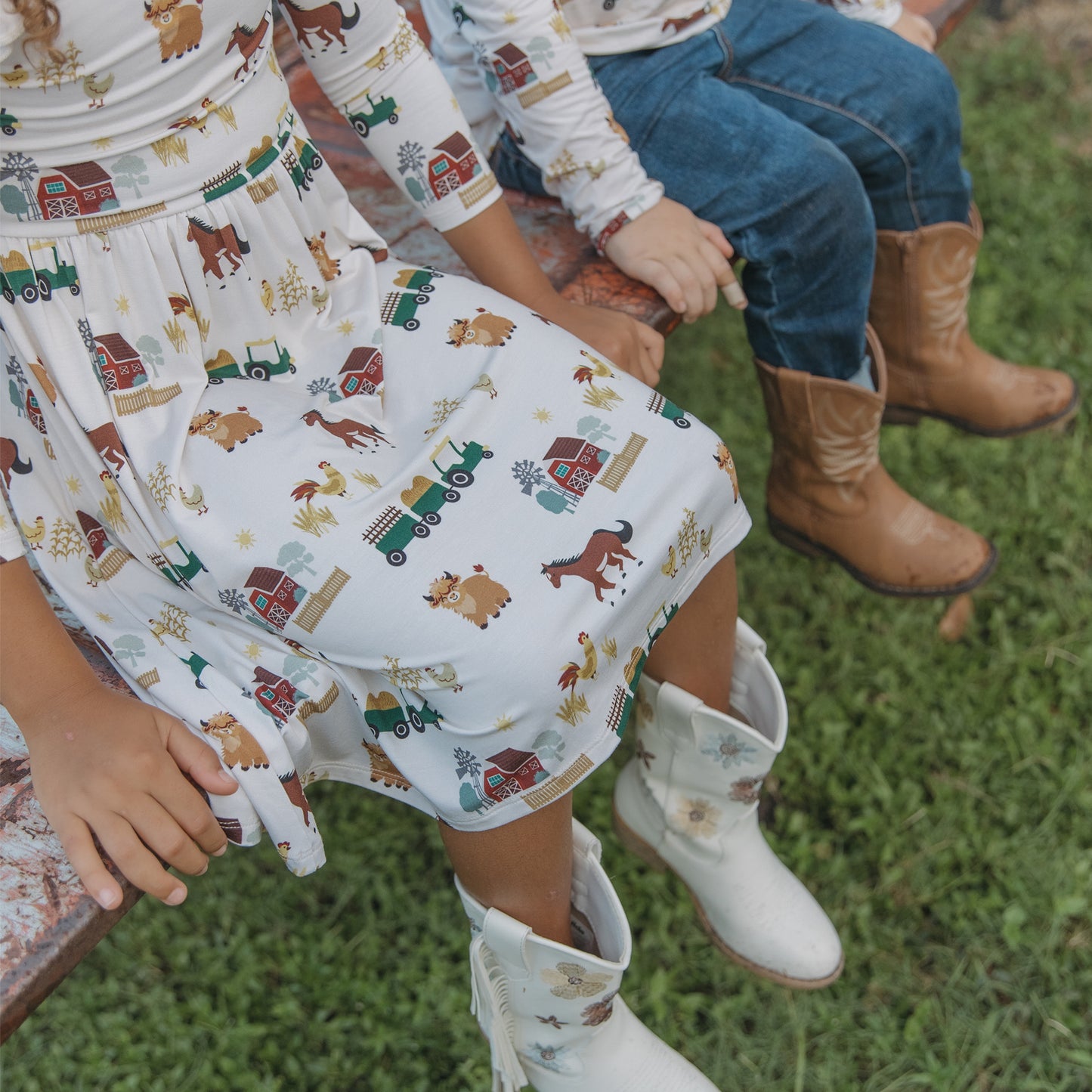 On the Farm bamboo twirl dress with ruffled sleeves and farm animal print detail, breathable and gentle for sensitive skin.