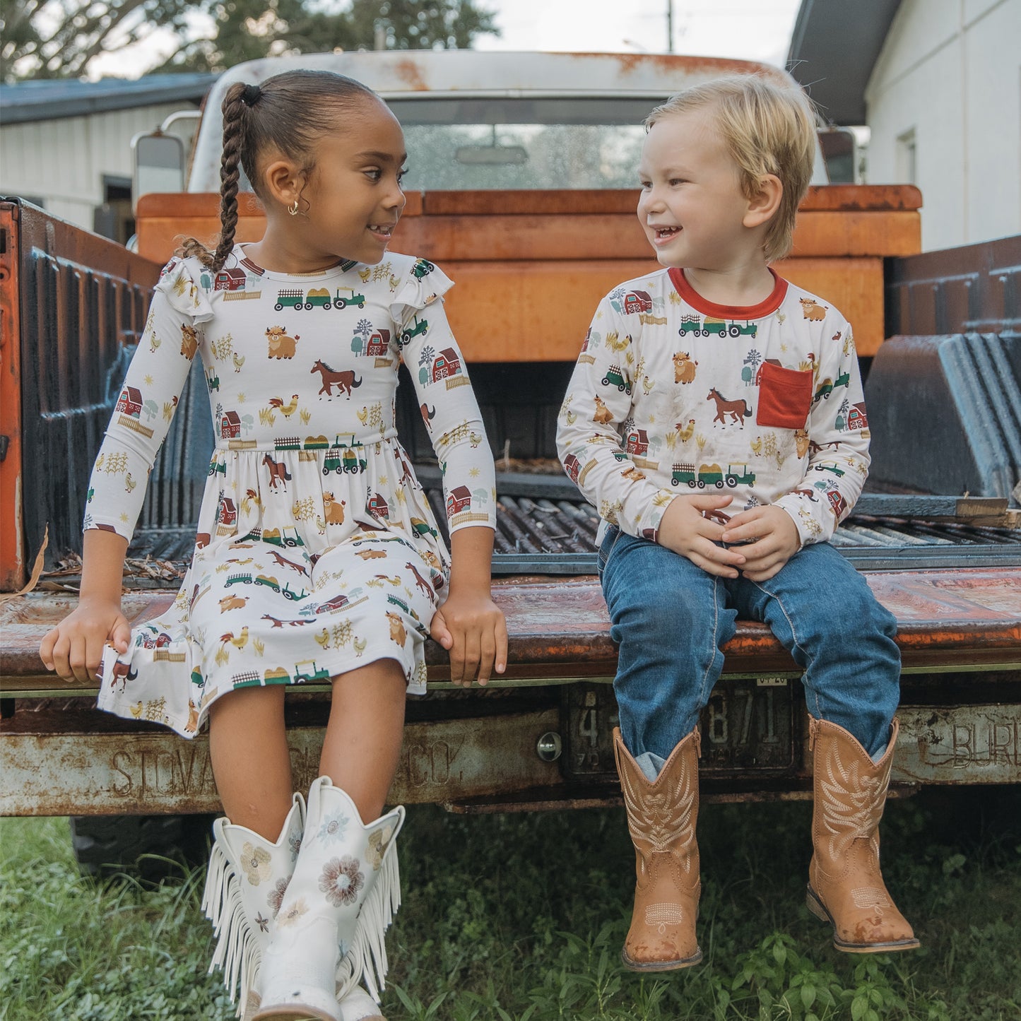Siblings in matching On the Farm bamboo pocket tees ad twirl dress with horse and tractor farm print, soft, breathable, and gentle on sensitive skin.