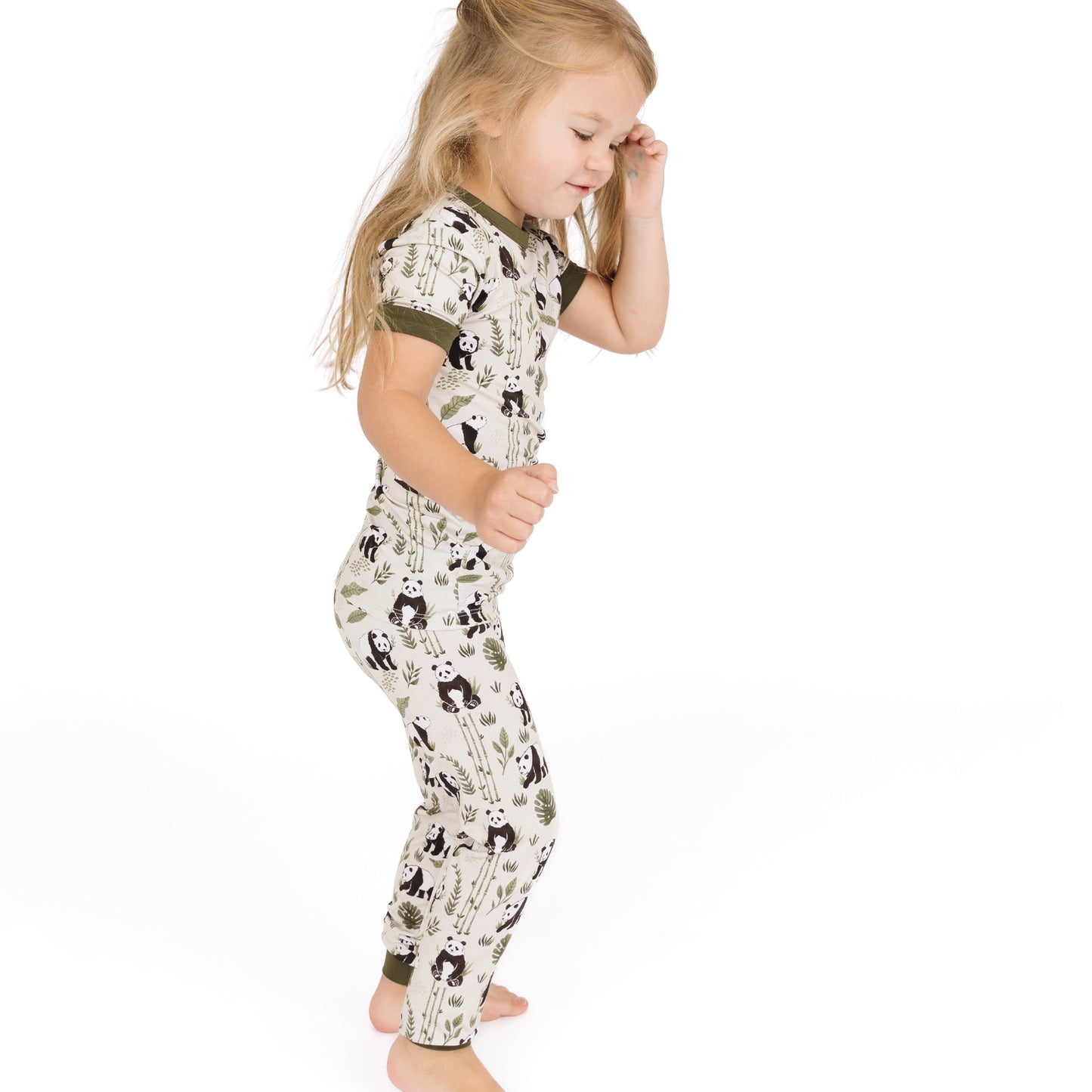Child wearing a patterned outfit on a white background