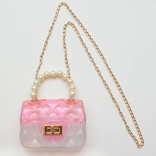 clear bag with pink on the top and a pearl handle and gold strap