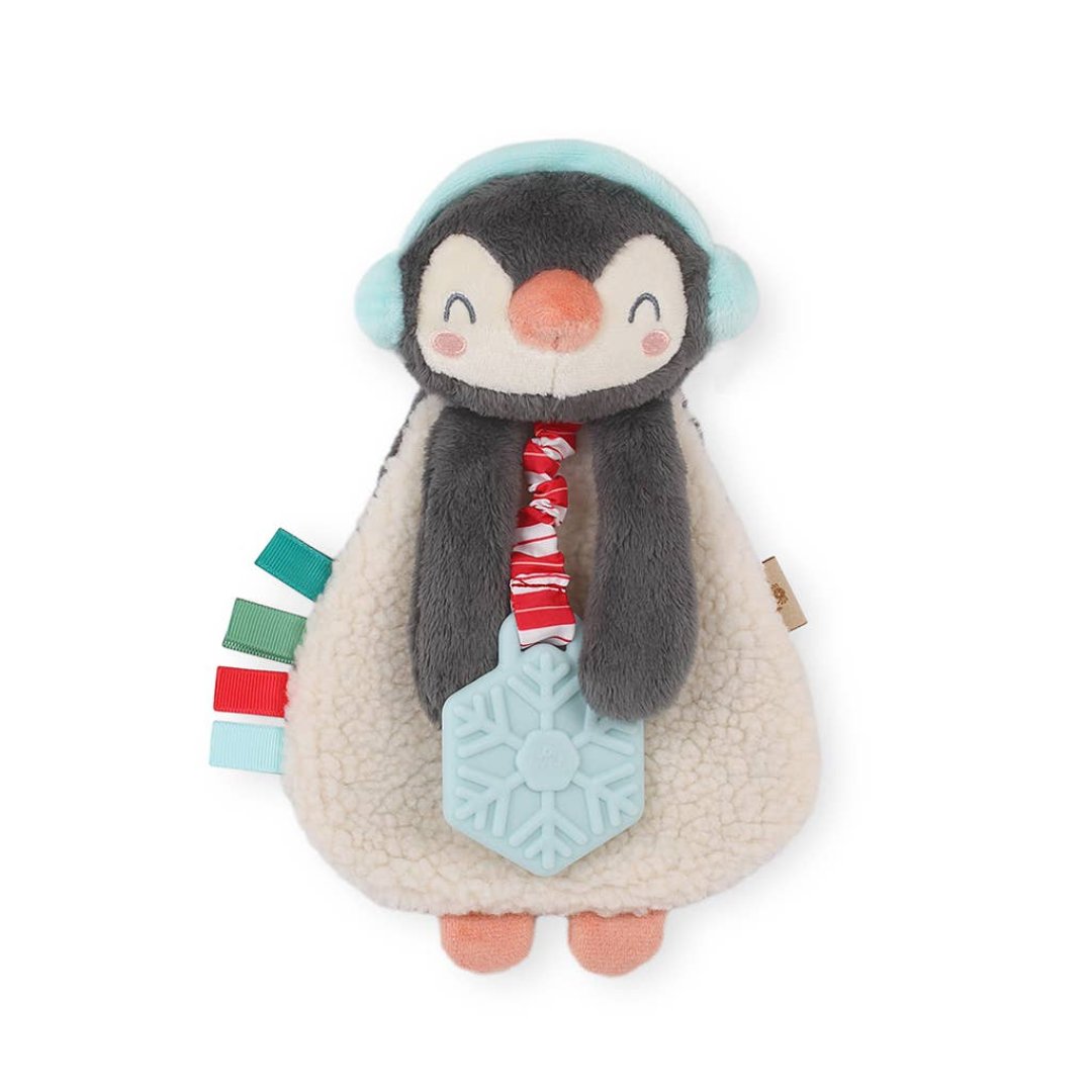 penguin plush toy with a teether attached thats shaped like a snowflake