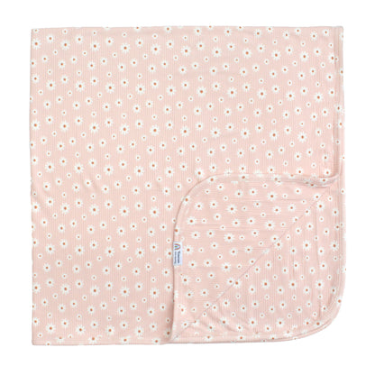 Pink baby blanket with white floral pattern on a white background