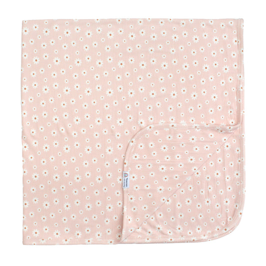 Pink baby blanket with white floral pattern on a white background