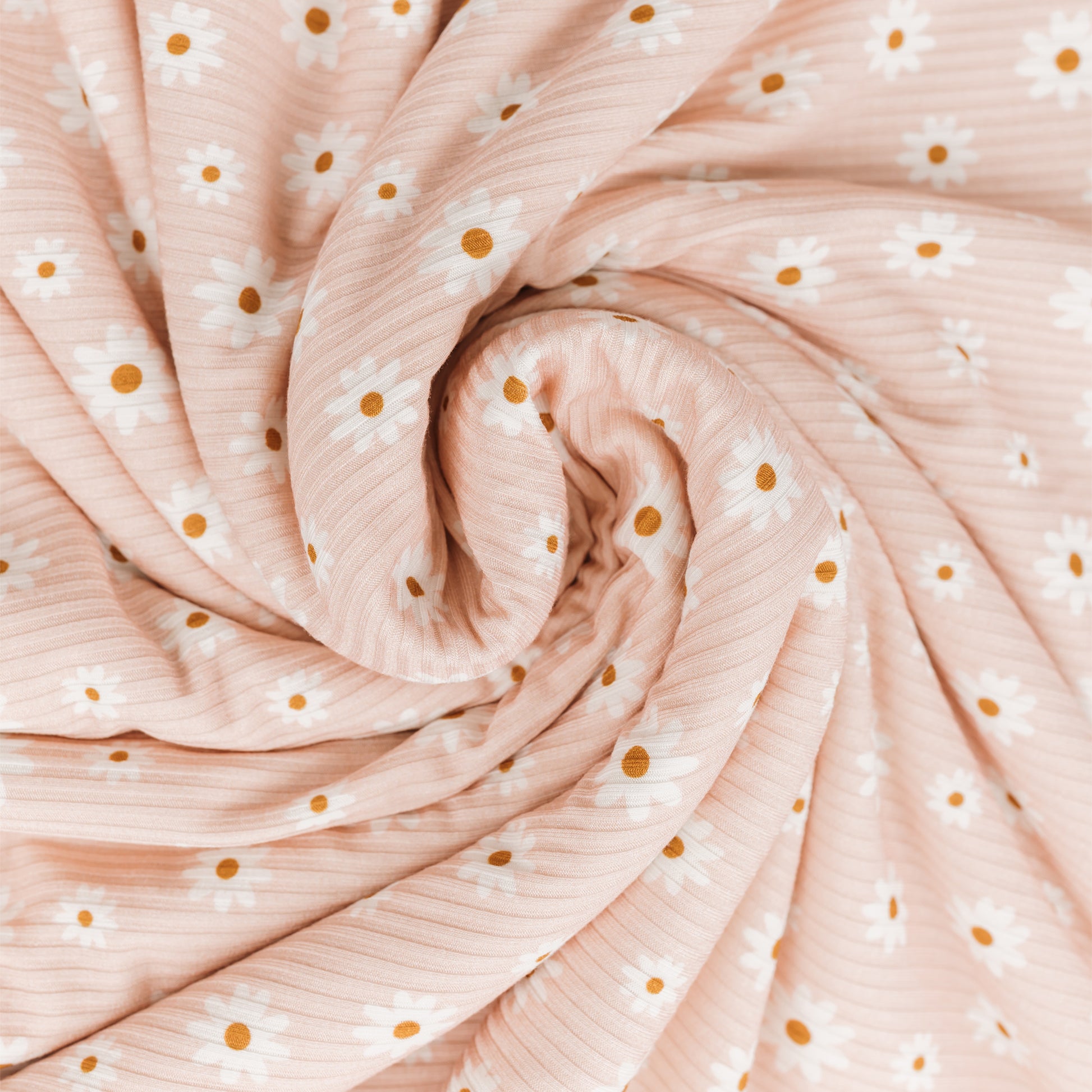 Roll of pink fabric with white and gold polka dots