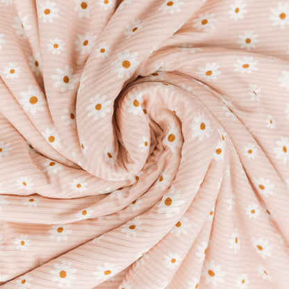 Roll of pink fabric with white and gold polka dots