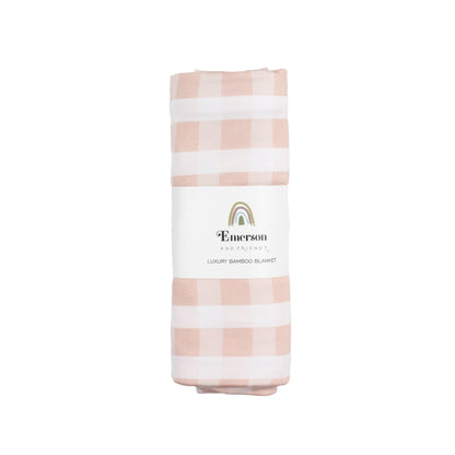 Folded pink and white checkered blanket with 'Emerson' branding on a white background