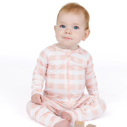 Baby wearing a pink and white striped onesie on a white background