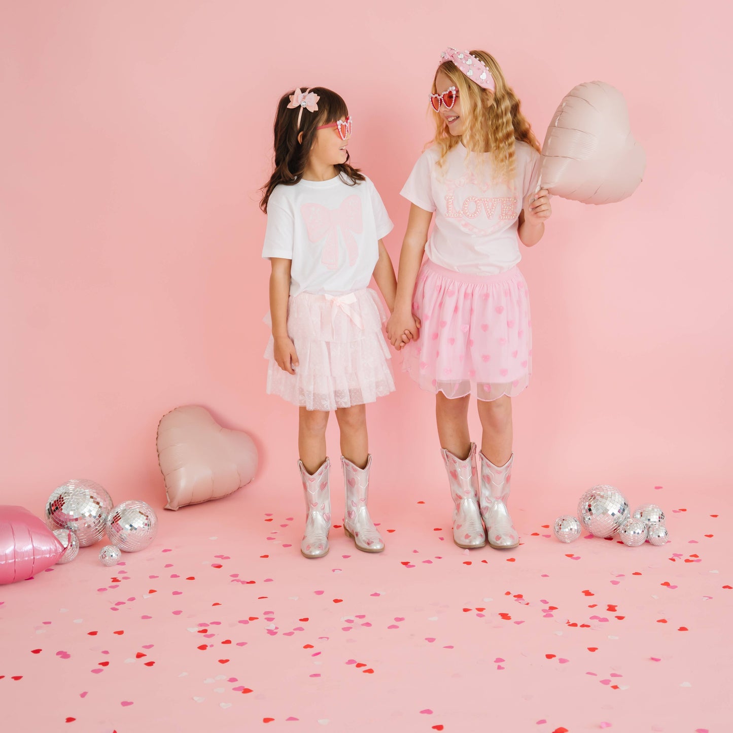 Girls wearing pink heart sequin tutu skirts for Valentine’s Day.