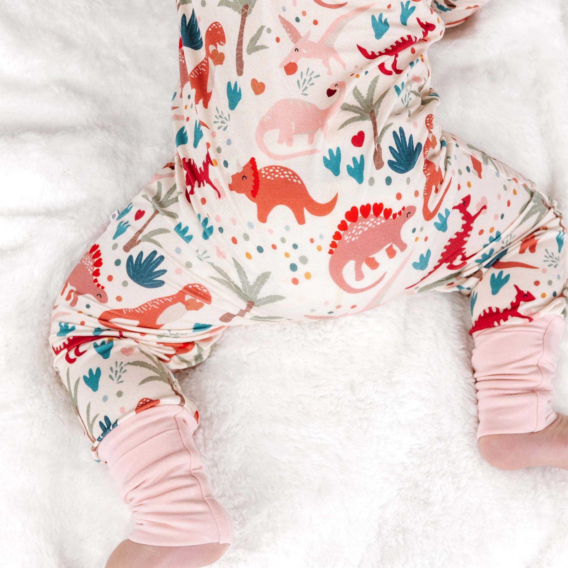 Back view of baby bamboo zip pajama with dinosaur print.