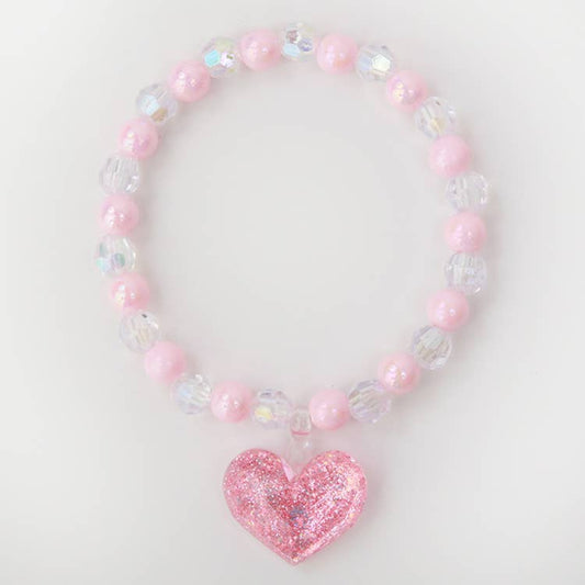 pink and clear beaded bracelet with a pink glittery charm