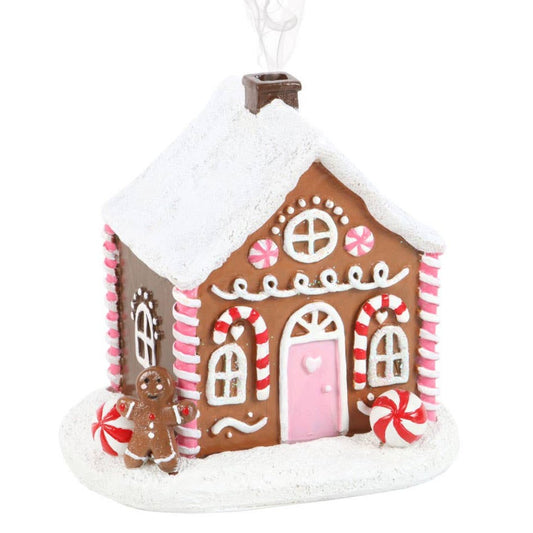 small ceramic gingerbread house incense burner with pink, white, and red accents 