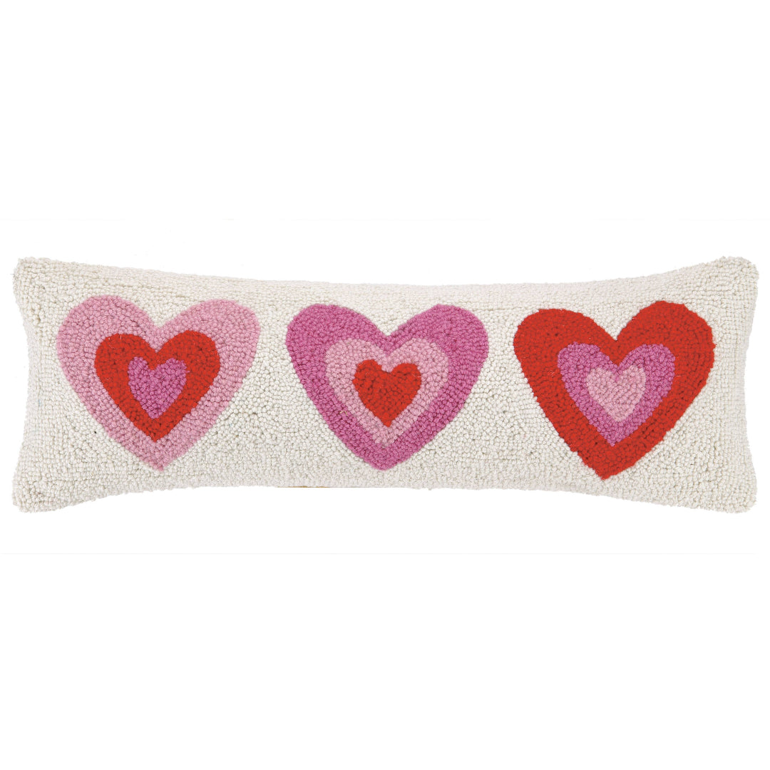 long hook pillow with 3 hearts on the front in red and pink