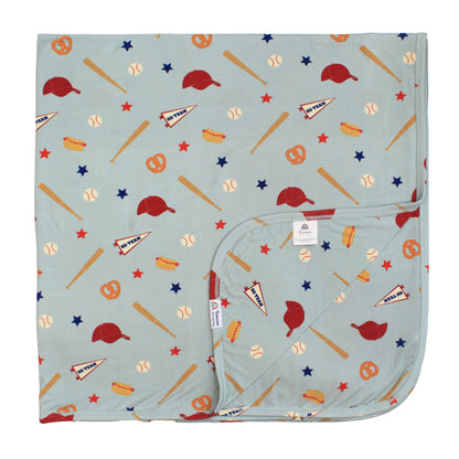 Baby blanket with baseball-themed pattern on a light blue background