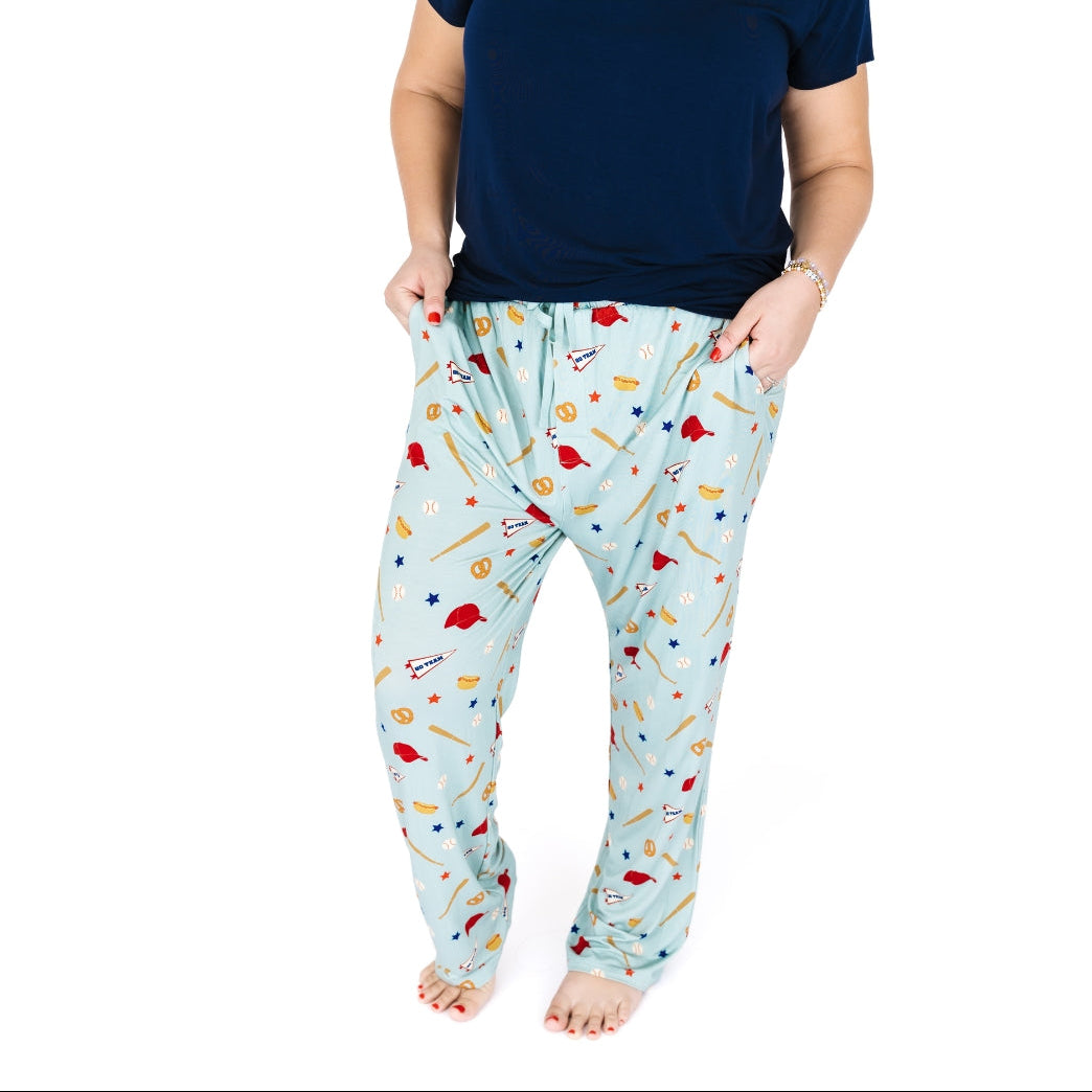 Person wearing light blue pajama pants with colorful patterns on a white background