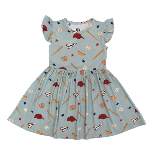 Children's dress with sports-themed pattern on a light blue background