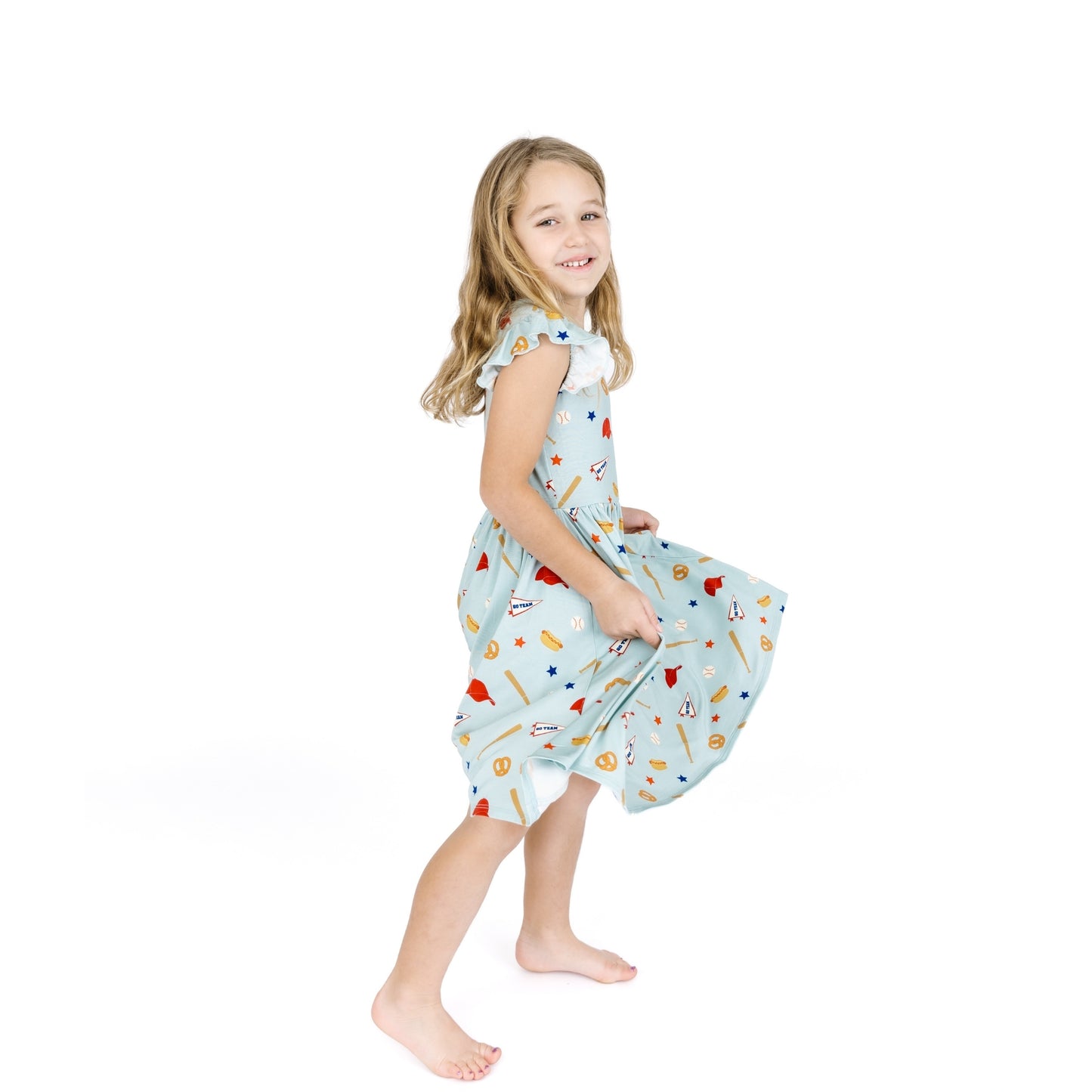 Young girl wearing a patterned dress on a white background
