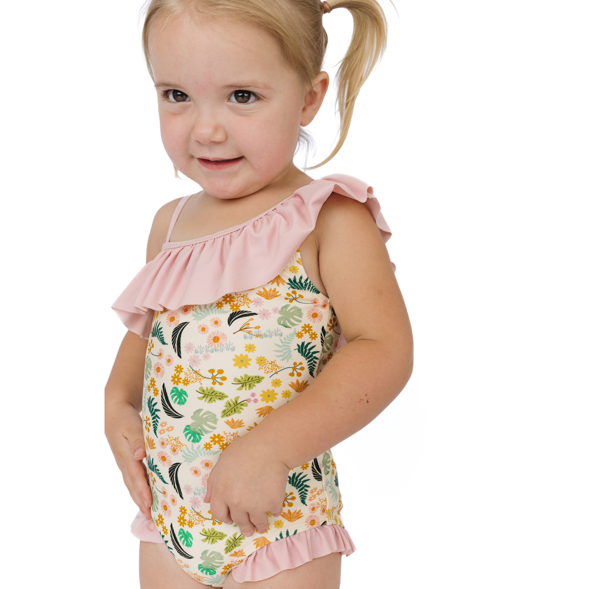 Girl wearing our Tropical Blooms one piece swimwear in a white background. 