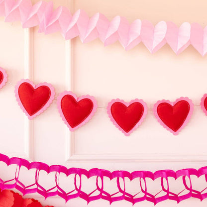 Heart-shaped decorations on a pink background