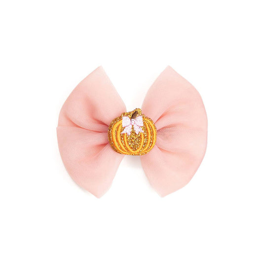 pink hair bow with an orange pumpkin in the middle