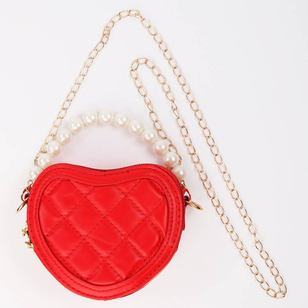 red heart shaped kids purse with a gold strap and pearl handle strap