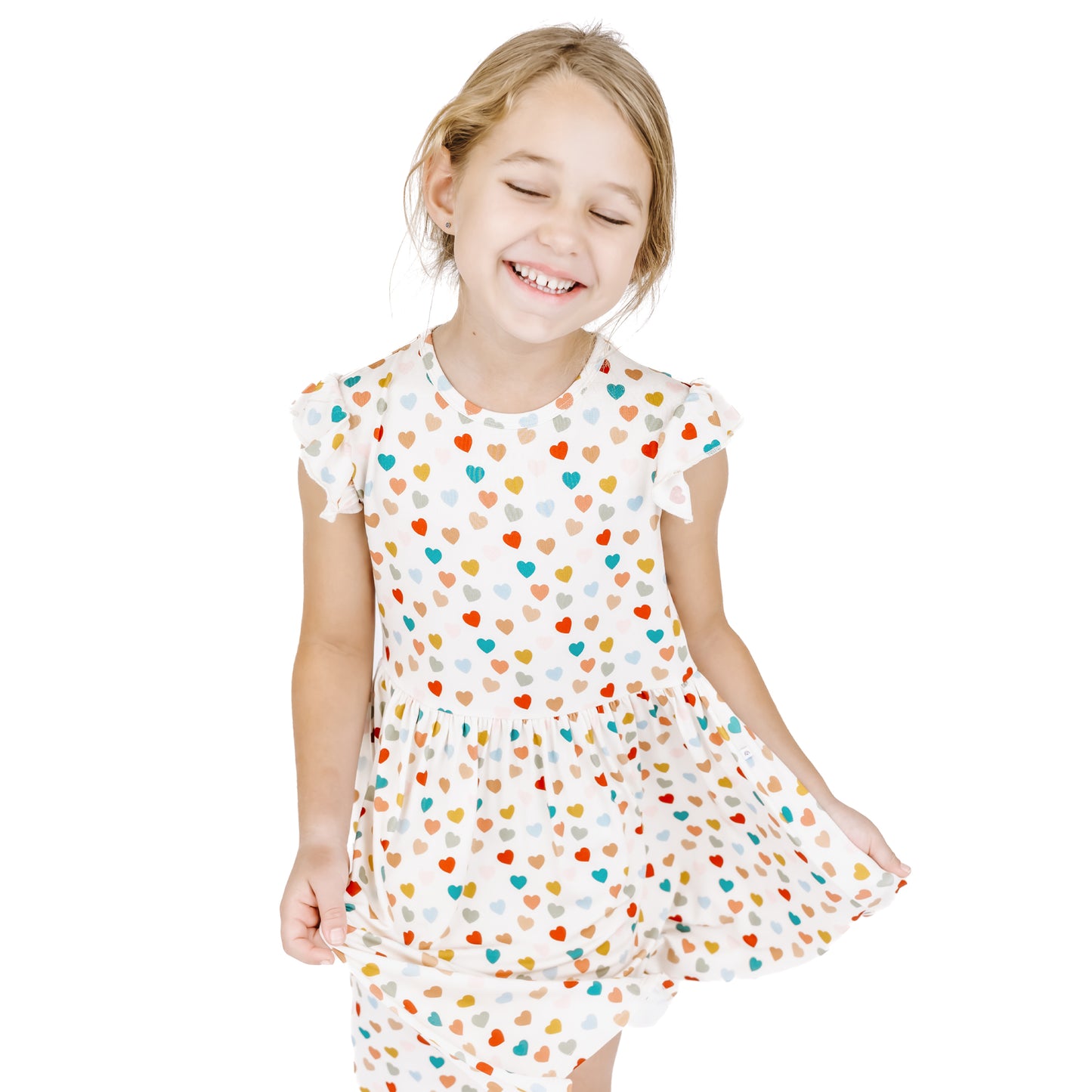 Child moving in Rainbow Hearts bamboo short sleeve twirl dress.