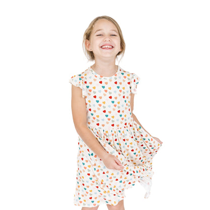 Smiling child in Rainbow Hearts bamboo twirl dress.