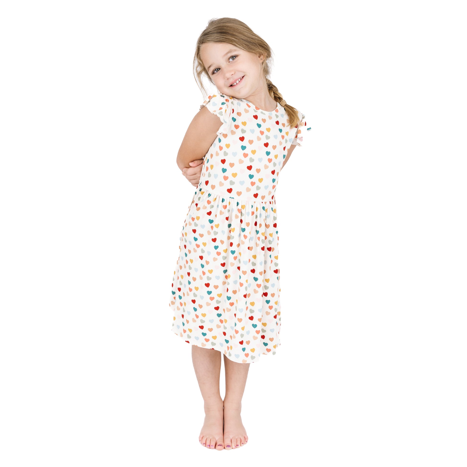 Child wearing Rainbow Hearts bamboo short sleeve twirl dress.