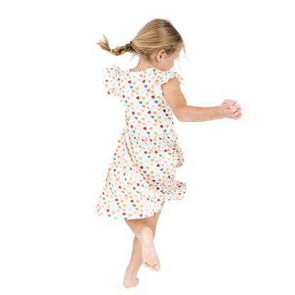 Child twirling in Rainbow Hearts bamboo short sleeve dress.