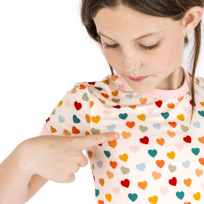 Close-up of Rainbow Hearts print on kids bamboo short sleeve pajamas.