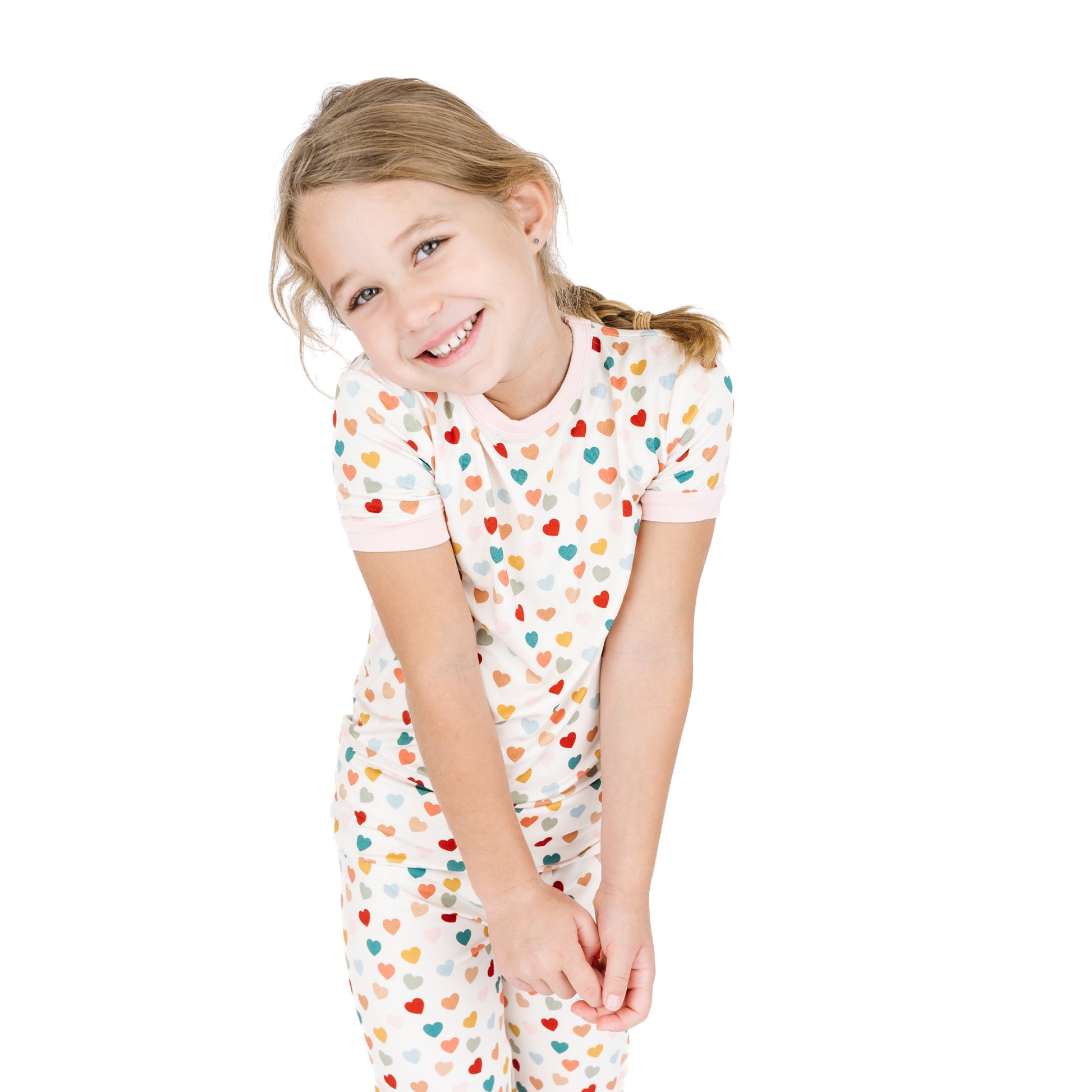 Child standing in Rainbow Hearts bamboo short sleeve pajama set.