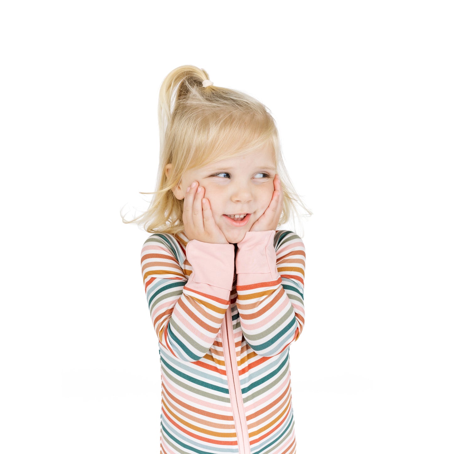 Young girl wearing a colorful striped sweater on a white background