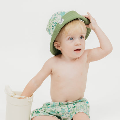 A beach-ready reversible bucket hat from the Save the Sea Turtle collection, designed for comfort and sun protection for little ones. Featuring an ocean-inspired print with adorable sea turtles and marine elements, this hat is perfect for sunny adventures.