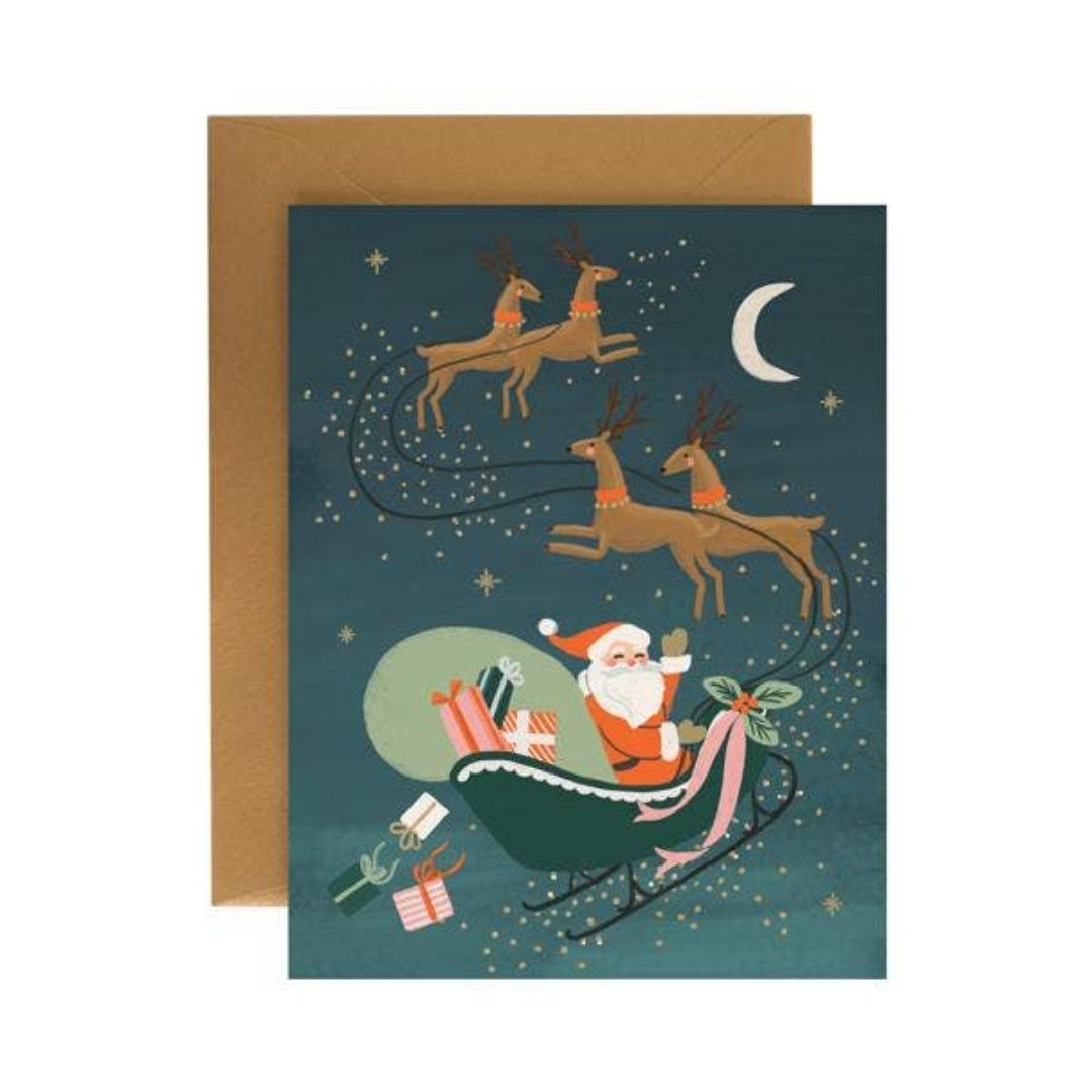 christmas card with santa riding his sleigh with reindeers in the night sky