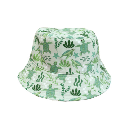 Save the Sea Turtles and Lucky Green Reversible Bucket Hat by Emerson and Friends, featuring an ocean-inspired turtle print on one side and a solid lucky green color on the other. Made from lightweight, quick-dry fabric perfect for sunny adventures.